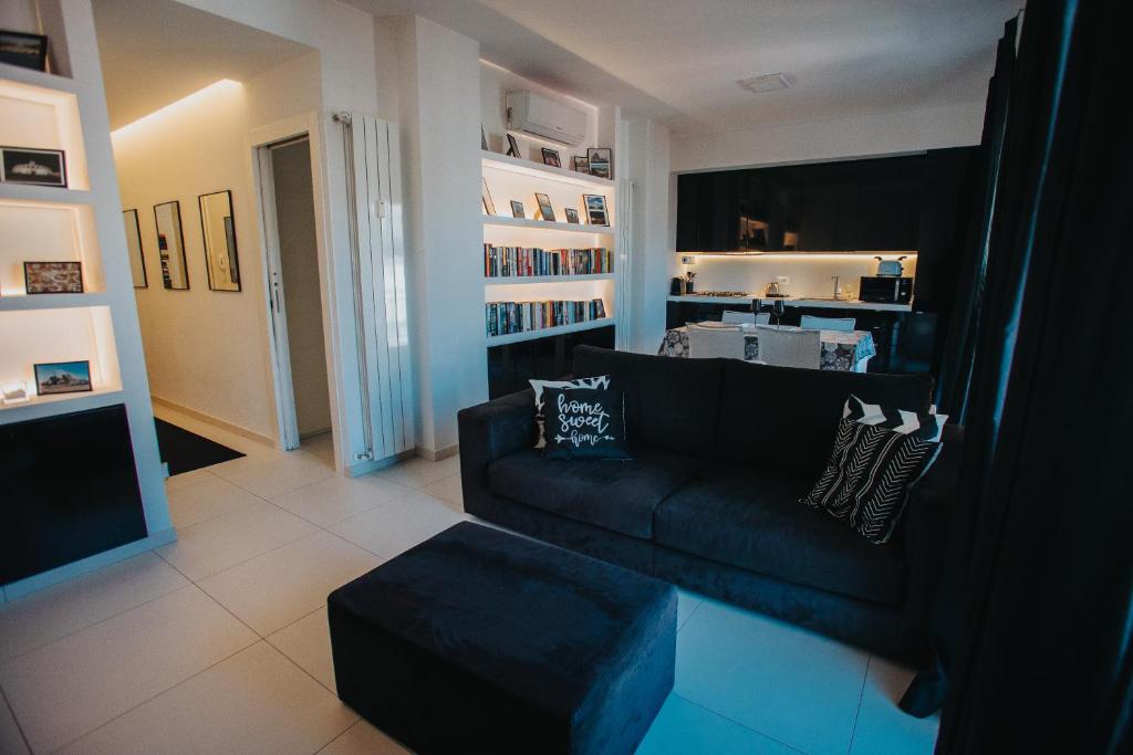 a living room with a couch and a book shelf at Principato di Baragallo - Free Private Parking in Sanremo