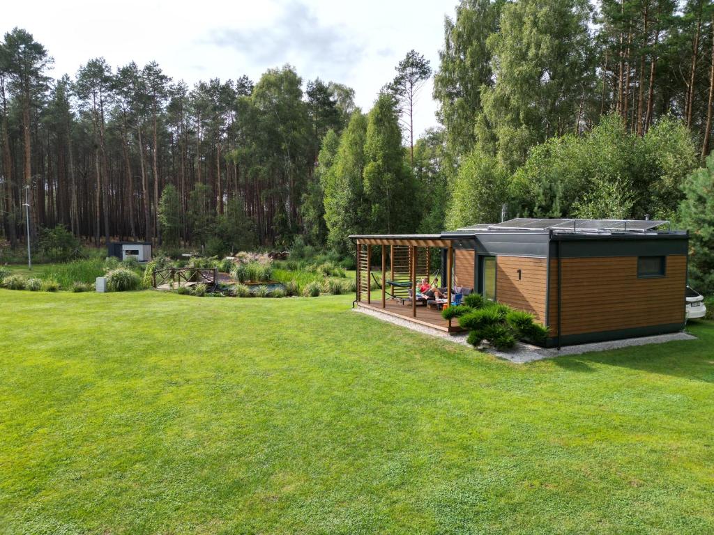 eine kleine Hütte inmitten eines Grasfeldes in der Unterkunft Agroturystyka Wena - luksus w naturze in Zachodźko