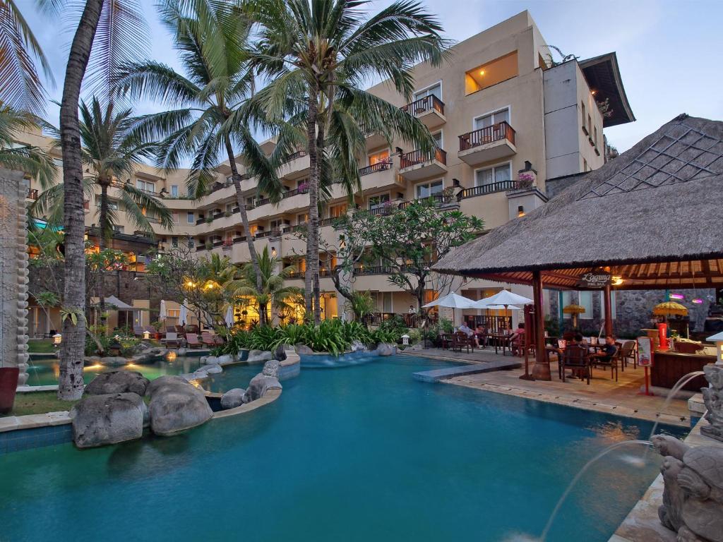 a swimming pool in front of a hotel at Kuta Paradiso Hotel in Kuta