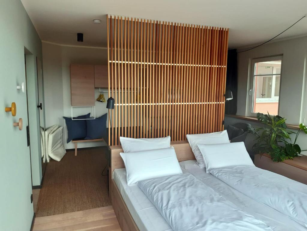 a bed with two pillows on it in a room at Designhotel Whitman in Ascheberg