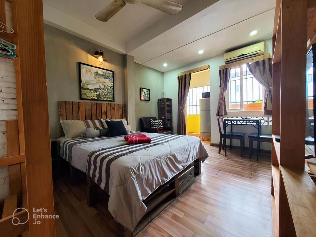 a bedroom with a bed and a dining room with a table at Deluxe Room D1/Dakao in Ho Chi Minh City