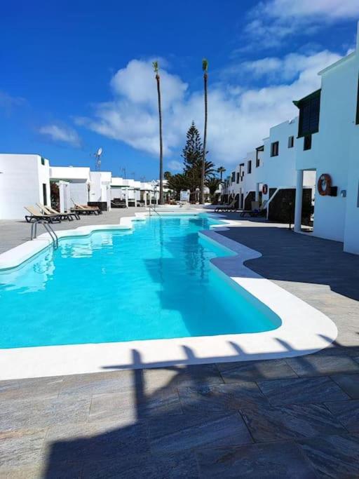 a large blue swimming pool in a resort at Casa Turquesa, shared pool in Puerto del Carmen