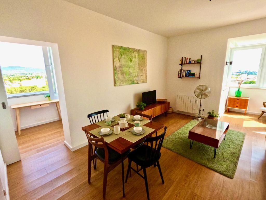 a living room with a table and a dining room at Peaceful & panoramic views apartment, Cascais in Cascais