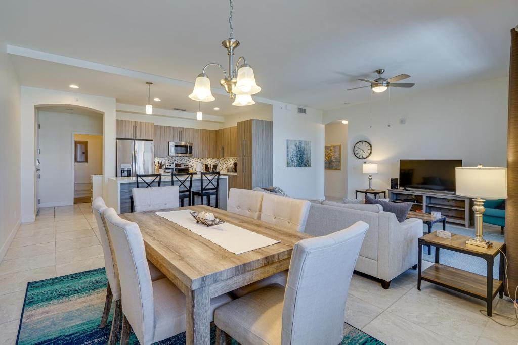 a dining room and living room with a table and chairs at Modern Fort Myers Condo Rental about 5 Mi to Beach! in Fort Myers