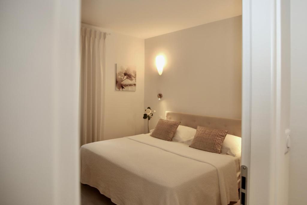 a bedroom with a bed with white sheets and brown pillows at Eze Villa in Èze