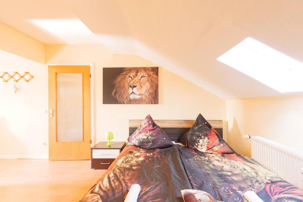 a bedroom with a bed with a lion picture on the wall at - 3-Bedroom Apartment Luxury: Central & Spacious in Duisburg & Big TV and Kitchen - in Duisburg