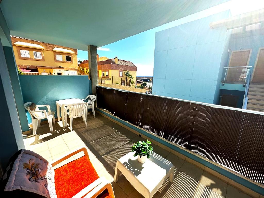 a balcony with a couch and a table on a building at Casa La Olas in Morro del Jable