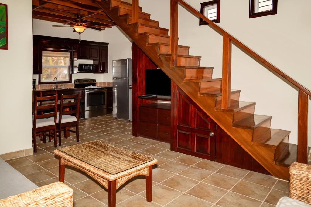 a living room with a staircase and a kitchen at X'tan Ha- The Waterfront in San Pedro
