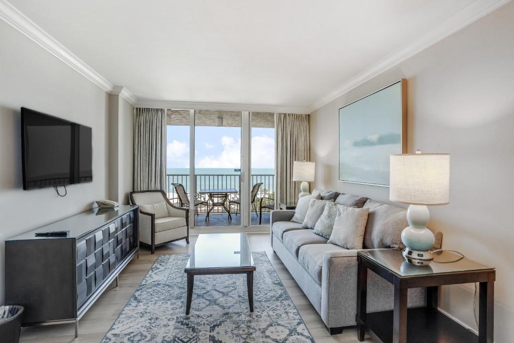 a living room with a couch and a tv at Marco Beach Ocean Resort 1102 in Marco Island