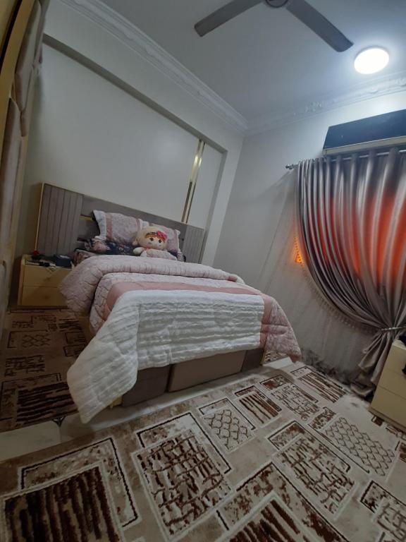 a bedroom with a bed and a rug on the floor at Erki Guest House in Abu Simbel