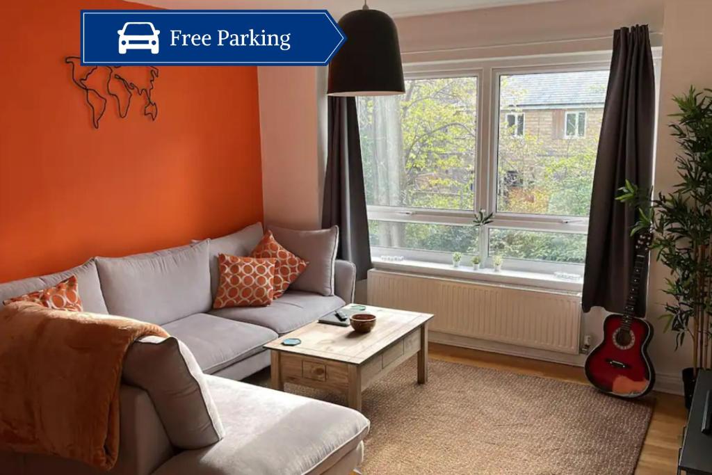 a living room with a couch and a table at Stylish 2Bed Apt in Leeds - Free Parking! in Headingley