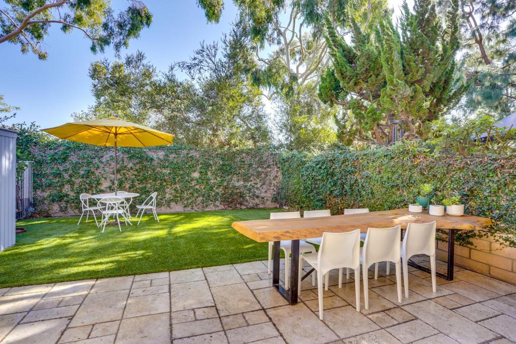 a patio with a table and chairs and an umbrella at 1 Mi to State Beach! Dog-Friendly Dana Point Condo in Dana Point