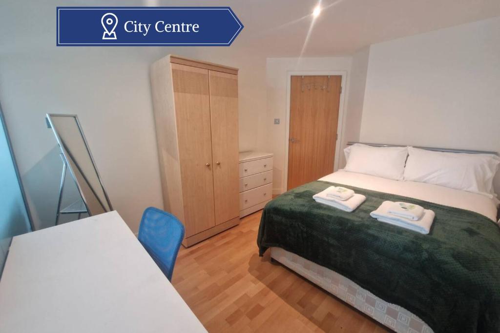 a bedroom with a bed with two towels on it at Spacious 1bed Apt in Leeds City Centre in Leeds