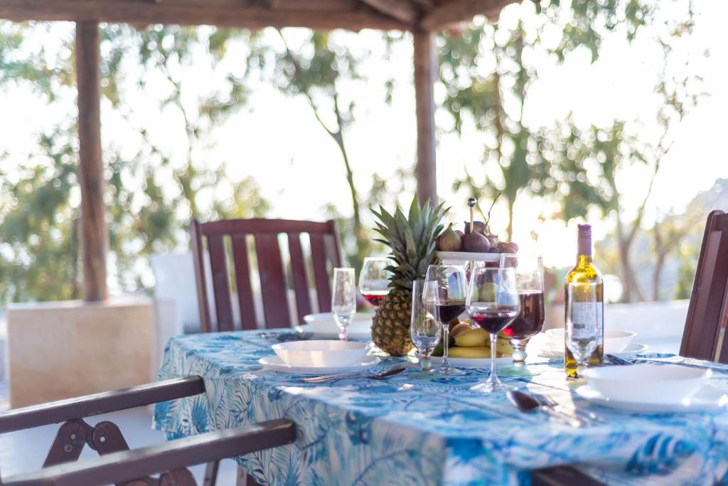 a table with a blue table cloth and wine bottles at Casa Giardinello in Ribera