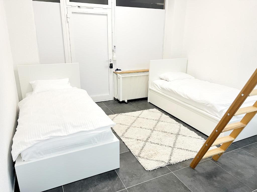 2 camas en una habitación con una escalera y una alfombra en Wohnung alleinige Nutzung 30qm 4 Schlafplätze Wiesbaden, en Walluf