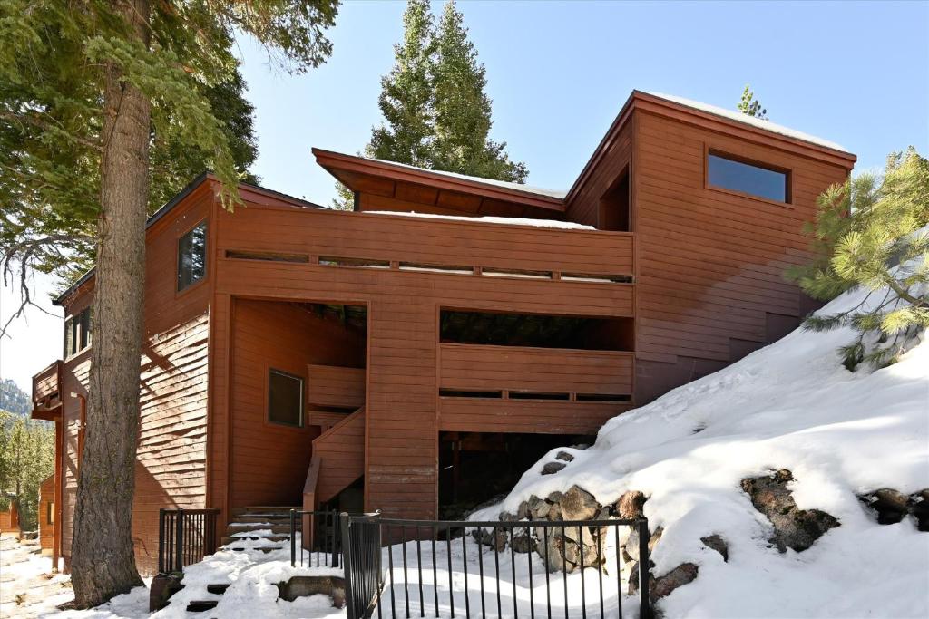 a house in the woods with snow on the ground at On the Edge at Alpine Meadows - Fireplace- Mountain Views- Great Location! Shuttle Service! in Olympic Valley