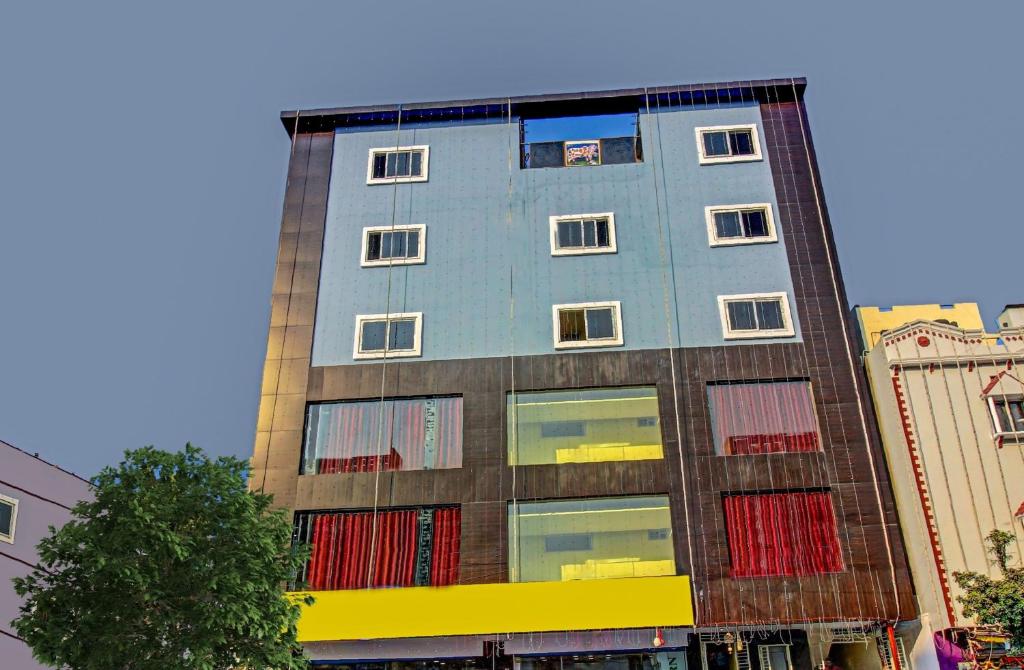 a tall building with colorful windows on a city street at Ab7 Residency Near Miraj Cinemas - Shalini Shivani in Hyderabad