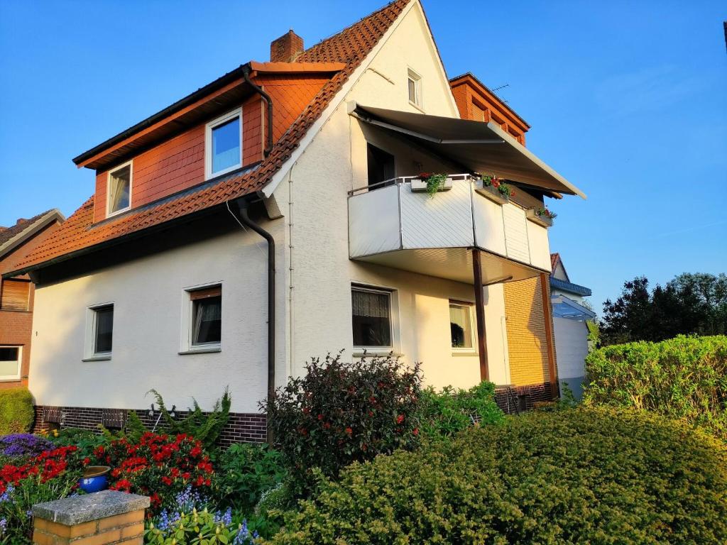 a house with a balcony on the side of it at Apartment in Bissendorf near Osnabrück in Bissendorf