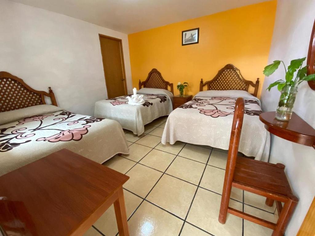 Postel nebo postele na pokoji v ubytování Hotel Posada Camelinas