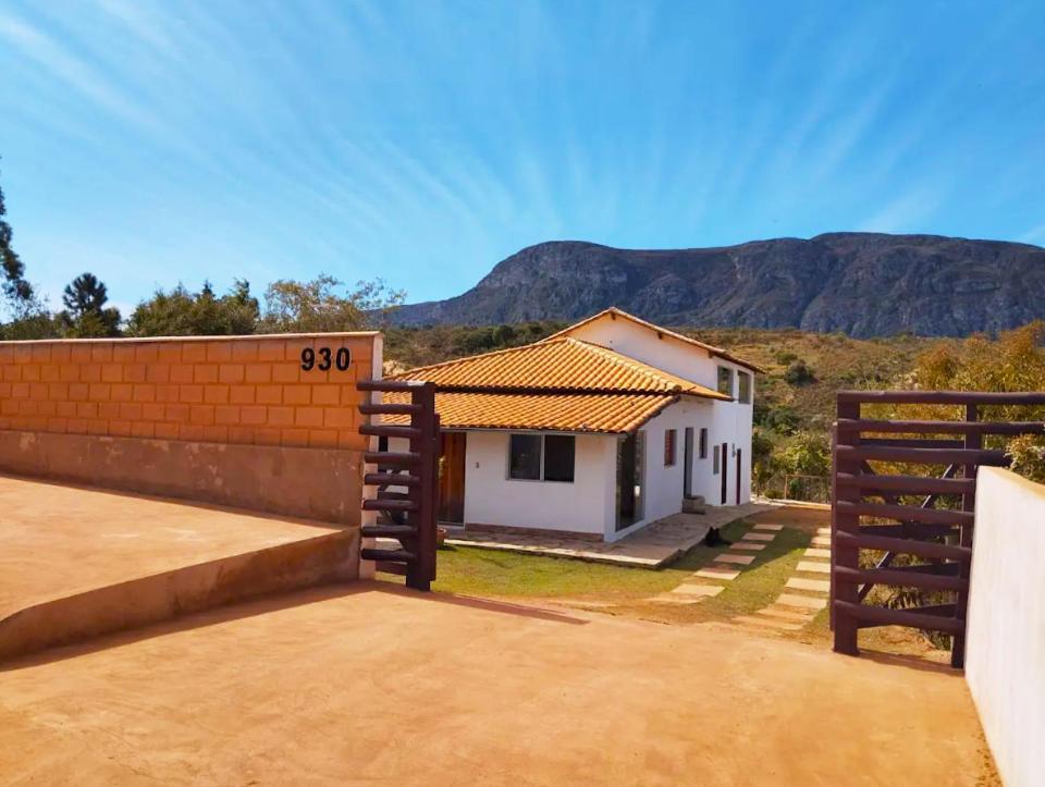 a house with a fence in front of it at HOSTEL DA LAPINHA in Santana do Riacho