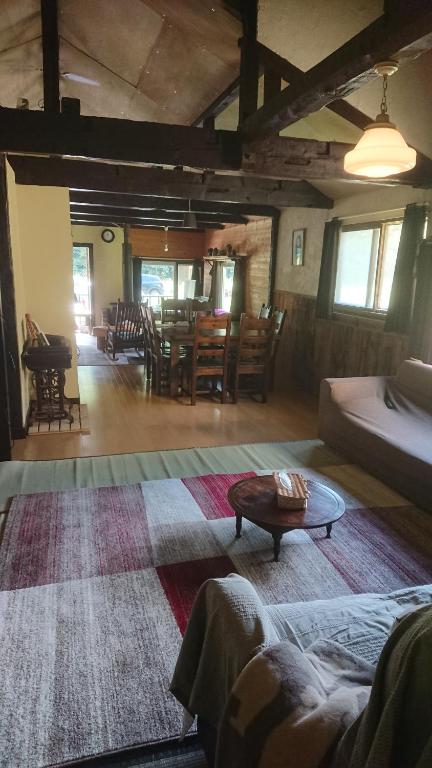 a living room with a couch and a table at Bears House in Furano