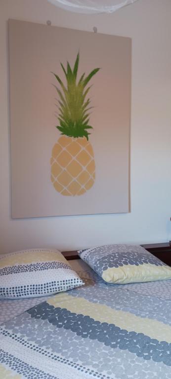 a bedroom with a pineapple on the head of a bed at Filassa Home, Villa à la Rivière de l'Est, Sainte Rose in Le Petit Brûlé