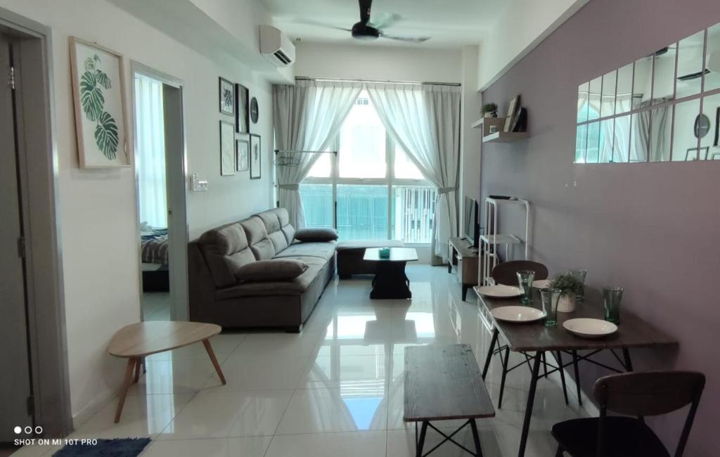 a living room with a couch and a table at Leisure homestay@Sutera Avenue 2-1007 in Kota Kinabalu