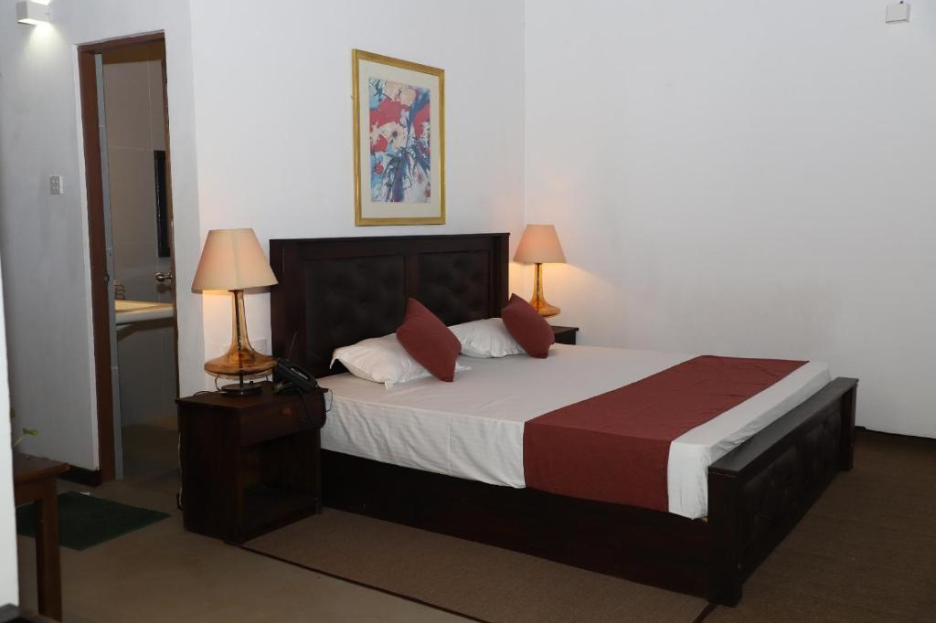 Postel nebo postele na pokoji v ubytování Hotel Ro Kalawewa