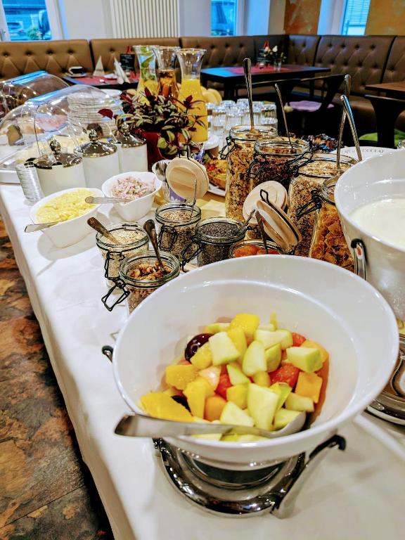 a table with a bowl of fruit on top of it at Café & mehr in Halle an der Saale