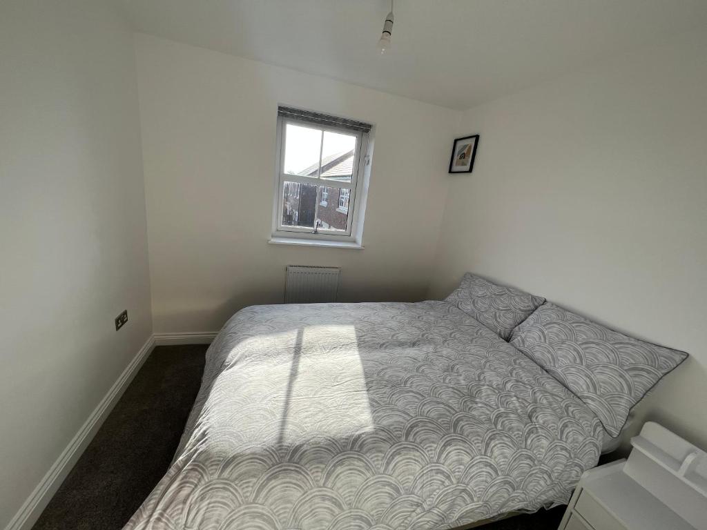 a bedroom with a bed and a window at Luxury 3 bedroom house on the outskirts of Newcastle near to Hadrians Wall in Newcastle upon Tyne