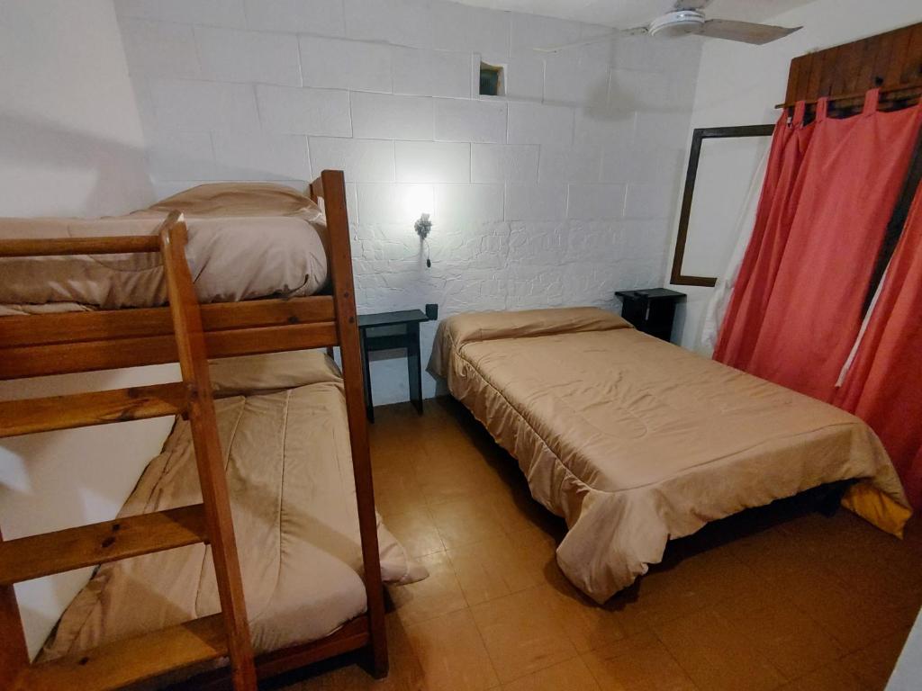 una habitación con dos literas y una mesa en Megaró, en Santa Teresita