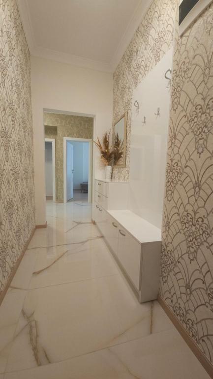a large room with white walls and a tile floor at Tsar Asen 21 in Sofia