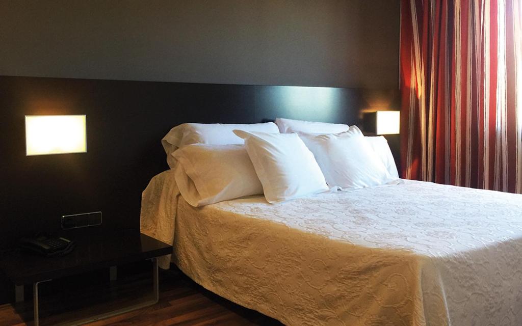 Postel nebo postele na pokoji v ubytování Hotel Bruc