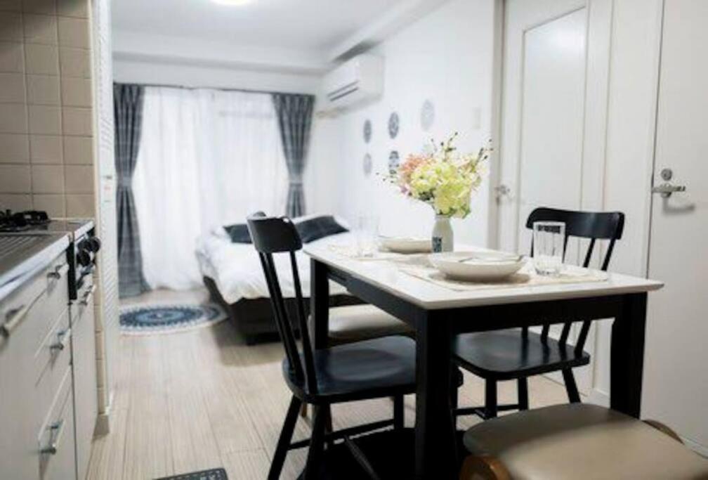 a kitchen and dining room with a table and chairs at Shinkoiwa Sta 5min!  Free Wi-Fi! Max 5 people. in Tokyo