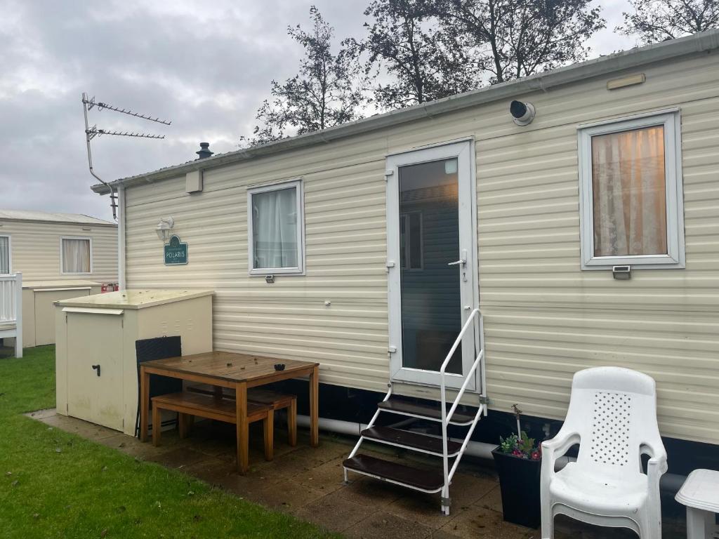 a tiny house with a ping pong table and a ladder at Haven caravan park Cala gran in Fleetwood