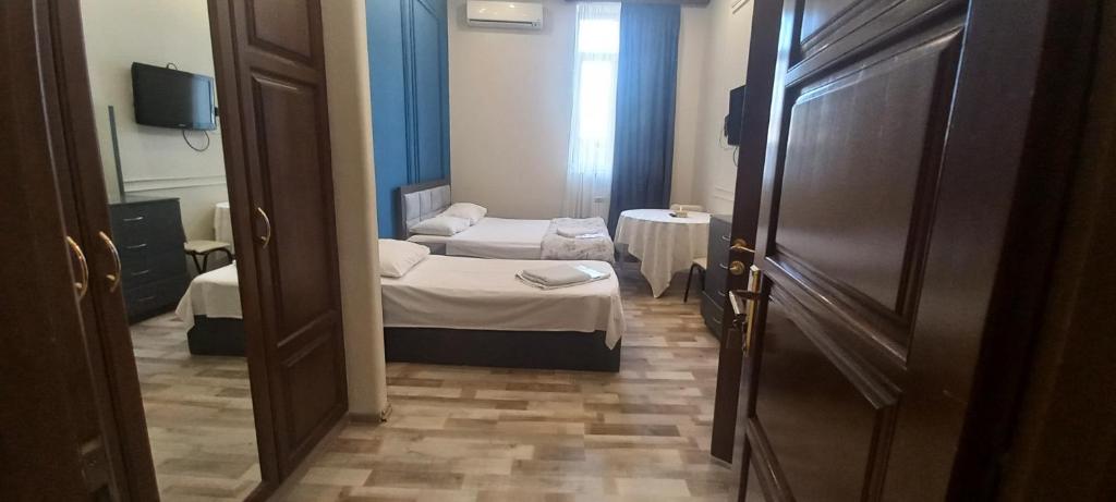 Postel nebo postele na pokoji v ubytování NEW BELLA HOTEL