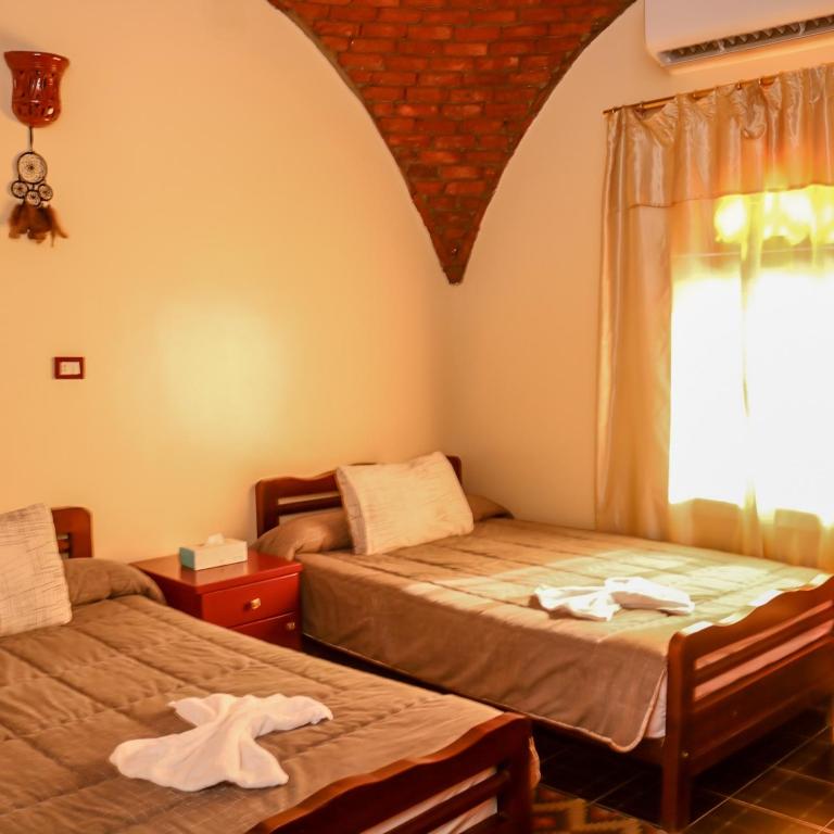 Postel nebo postele na pokoji v ubytování Wanas Kato Guest House