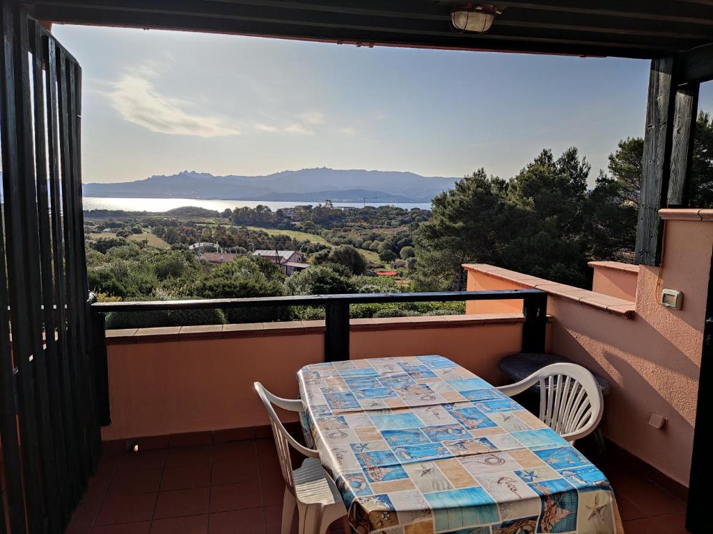 a table and chairs on a balcony with a view at TancaManna16 in Cannigione