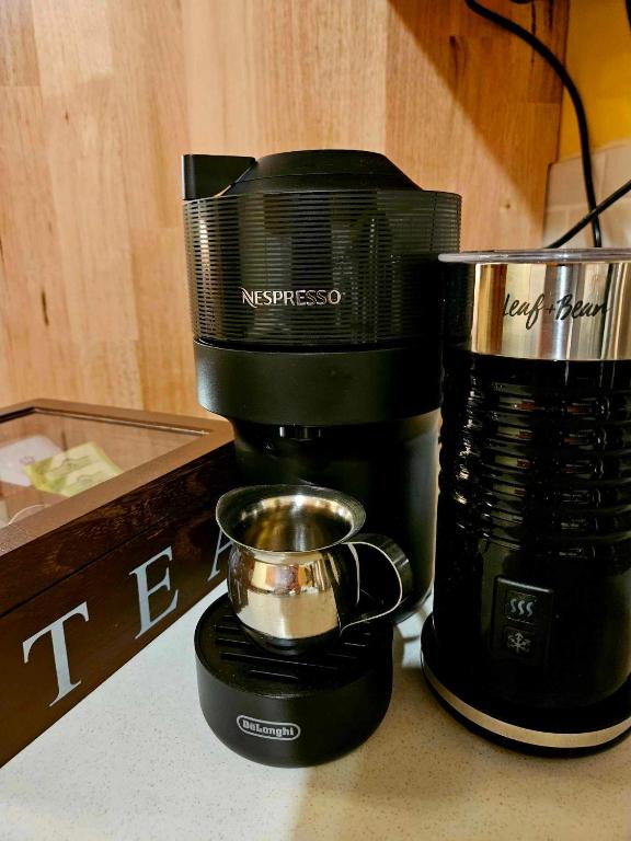 a coffee maker sitting on a counter next to a coffee pot at The Gamekeepers Spa Cottage in Tamborine Mountain in Mount Tamborine