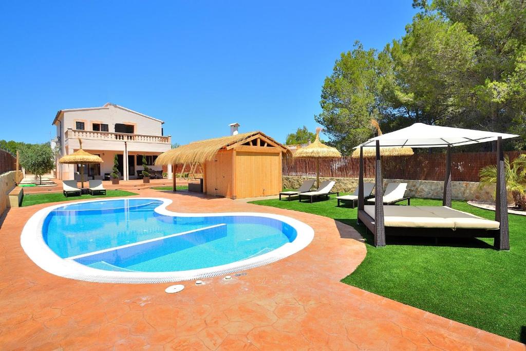 a swimming pool in a yard with an umbrella at 066 Villa Mexic 41 ETV8816 by Mallorca Charme in Santa Margalida