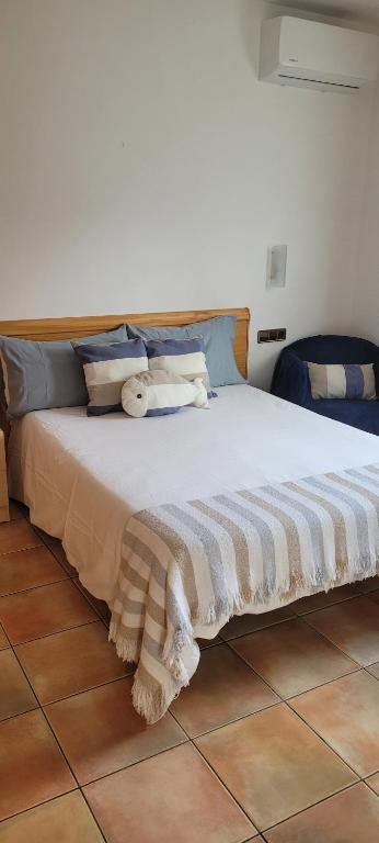 a bedroom with a large bed with towels on it at Can Carbó in Pals
