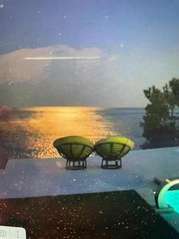 two lights on a table with a view of the ocean at ocean Island villa Achlia in Ierapetra