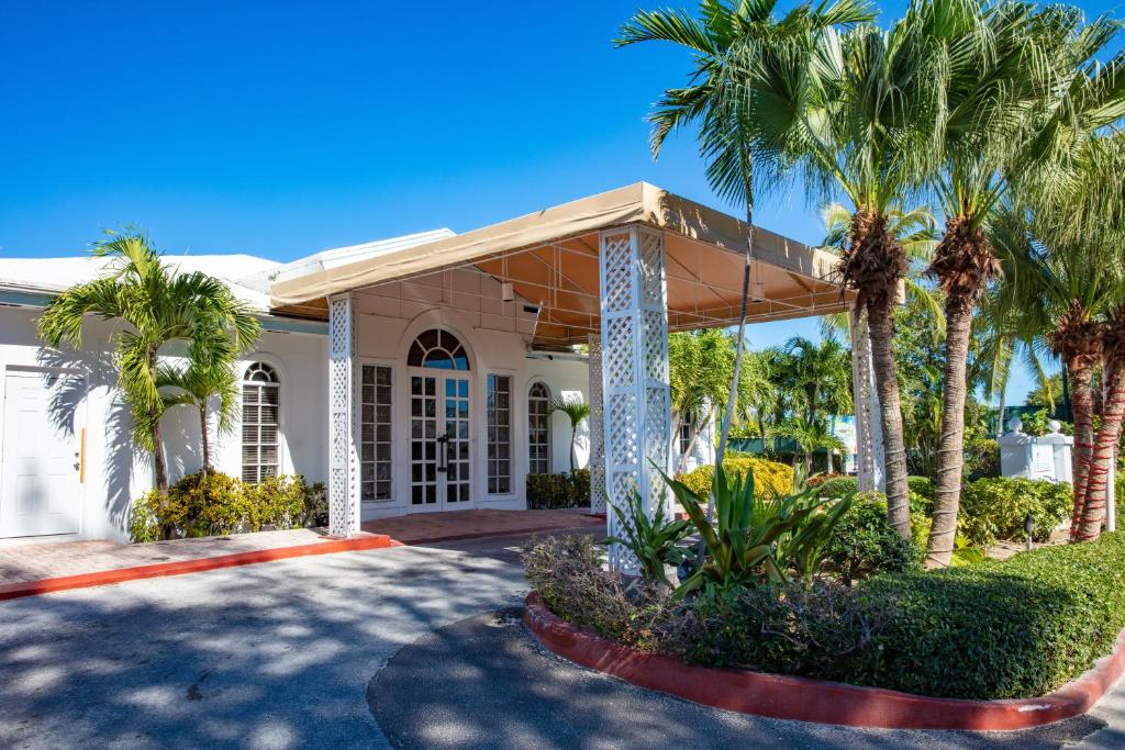 a house with palm trees in front of it at Ocean View Villas at Paradise Island Beach Club in Creek Village