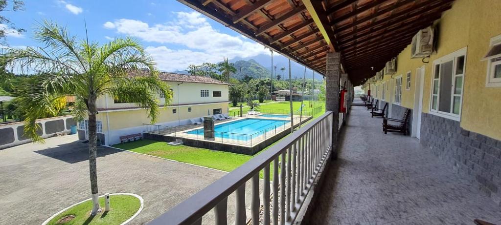 a balcony of a house with a swimming pool at Pousada Pau Brasil in Guapimirim