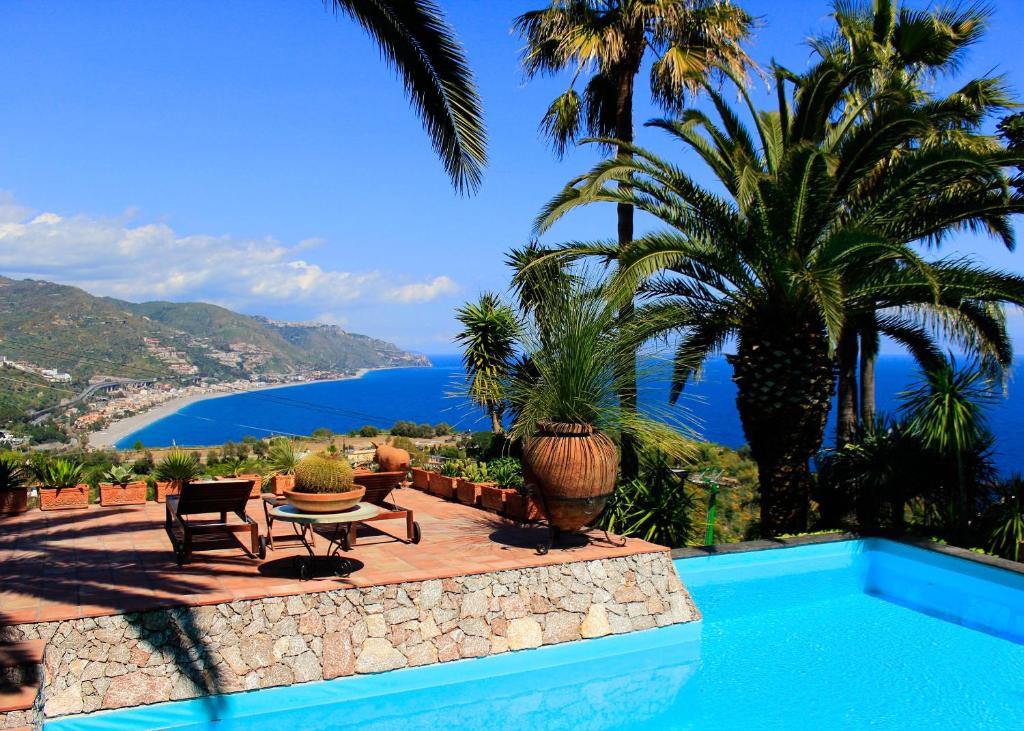 a swimming pool with a view of the ocean at VILLA LOU TAORMINA Exclusive Use of Pool in Taormina