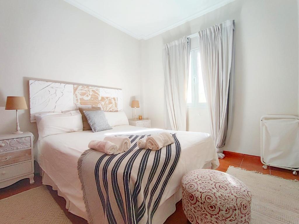 a bedroom with a bed with two towels on it at Duodecima in Las Palmas de Gran Canaria