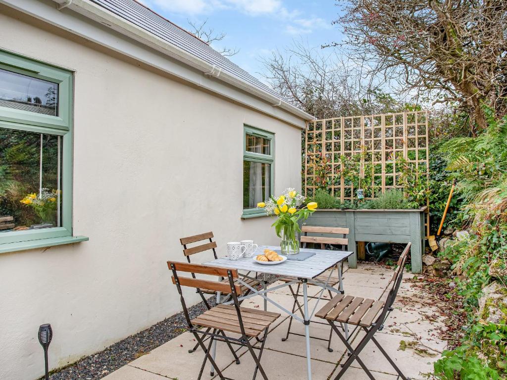 a patio with a table and chairs and a piano at Meadow View - Uk44608 in Carnbrea
