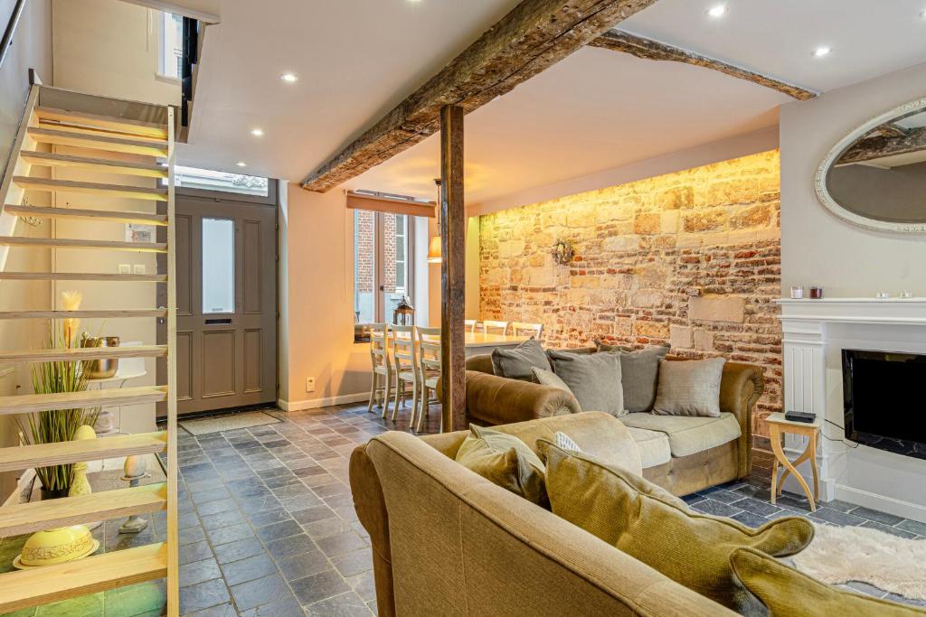 a living room with a couch and a fireplace at Bibi Tongeren in Tongeren