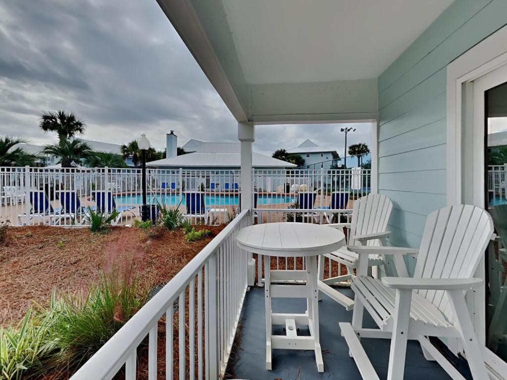 a porch with a table and chairs on a balcony at Beachside Villas 911 in Seagrove Beach