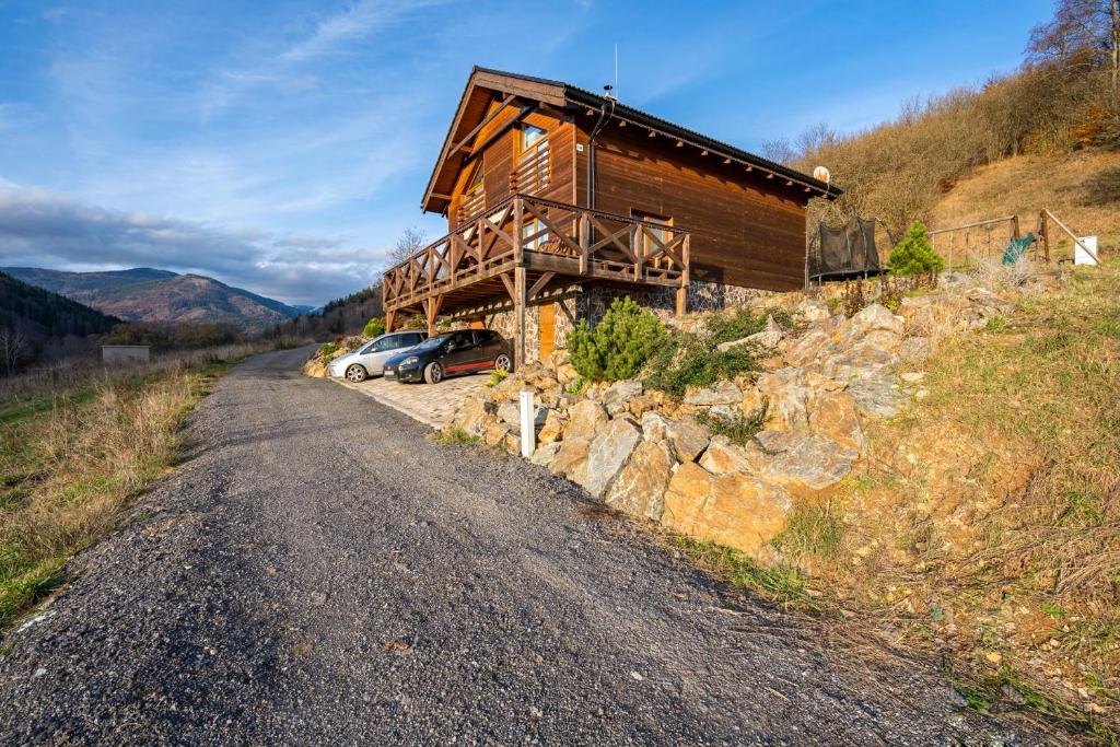 a house with a car parked on the side of a road at Chalet Bystra - wellness 5 min-washer-game room-view-5 bedrooms in Mýto pod Ďumbierom